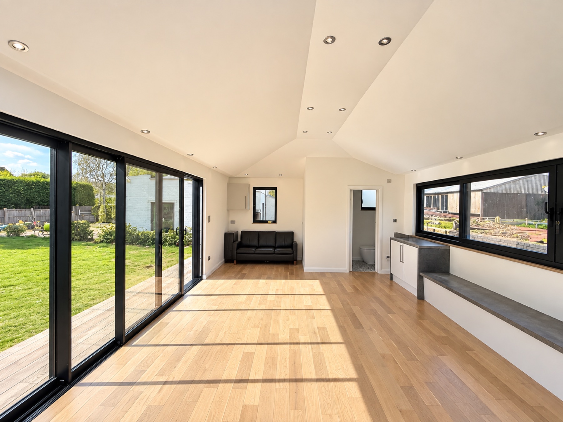 Finished Maidenhead entertainment garden room with vaulted ceiling, oak flooring, sliding glass doors and kitchenette